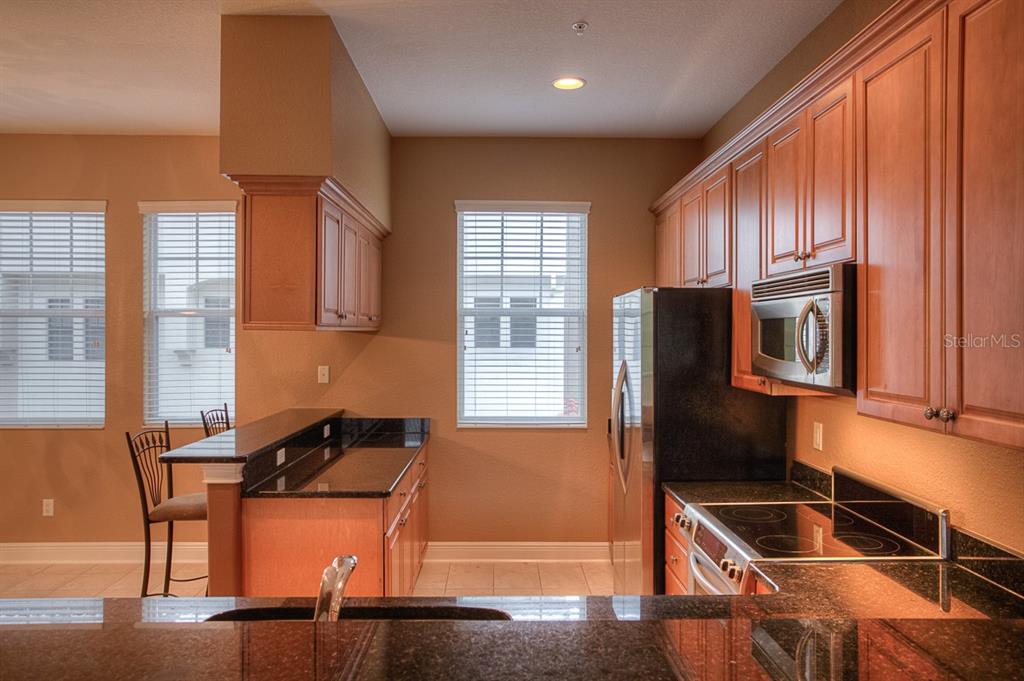6021 Printery Street, Unit 106 Tampa, FL 33616 - Photo 8 of 23 a kitchen with a refrigerator and a sink