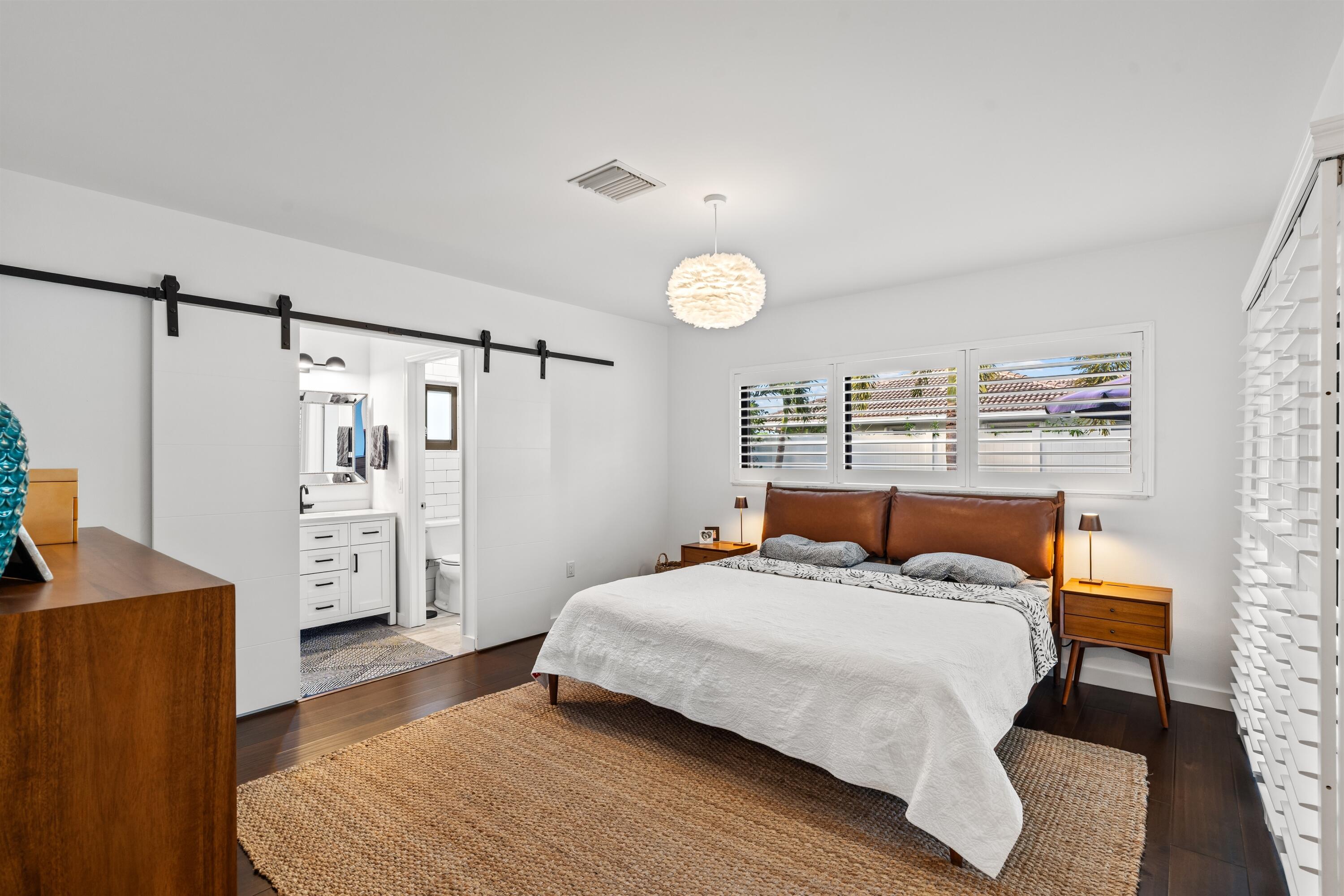 833 Northwest 6th Terrace Boca Raton, FL 33486 - Photo 19 of 49 a bedroom with a bed and a refrigerator