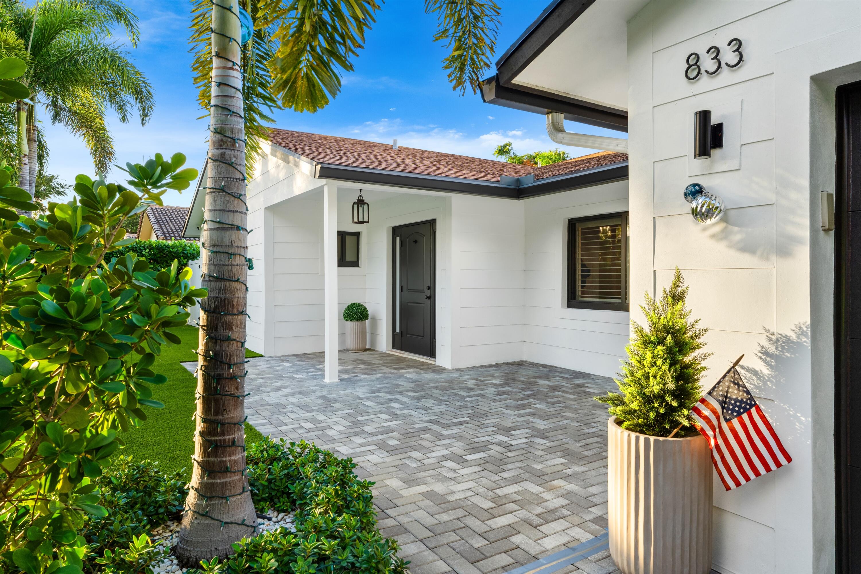 833 Northwest 6th Terrace Boca Raton, FL 33486 - Photo 7 of 49 a front view of a house with a small yard