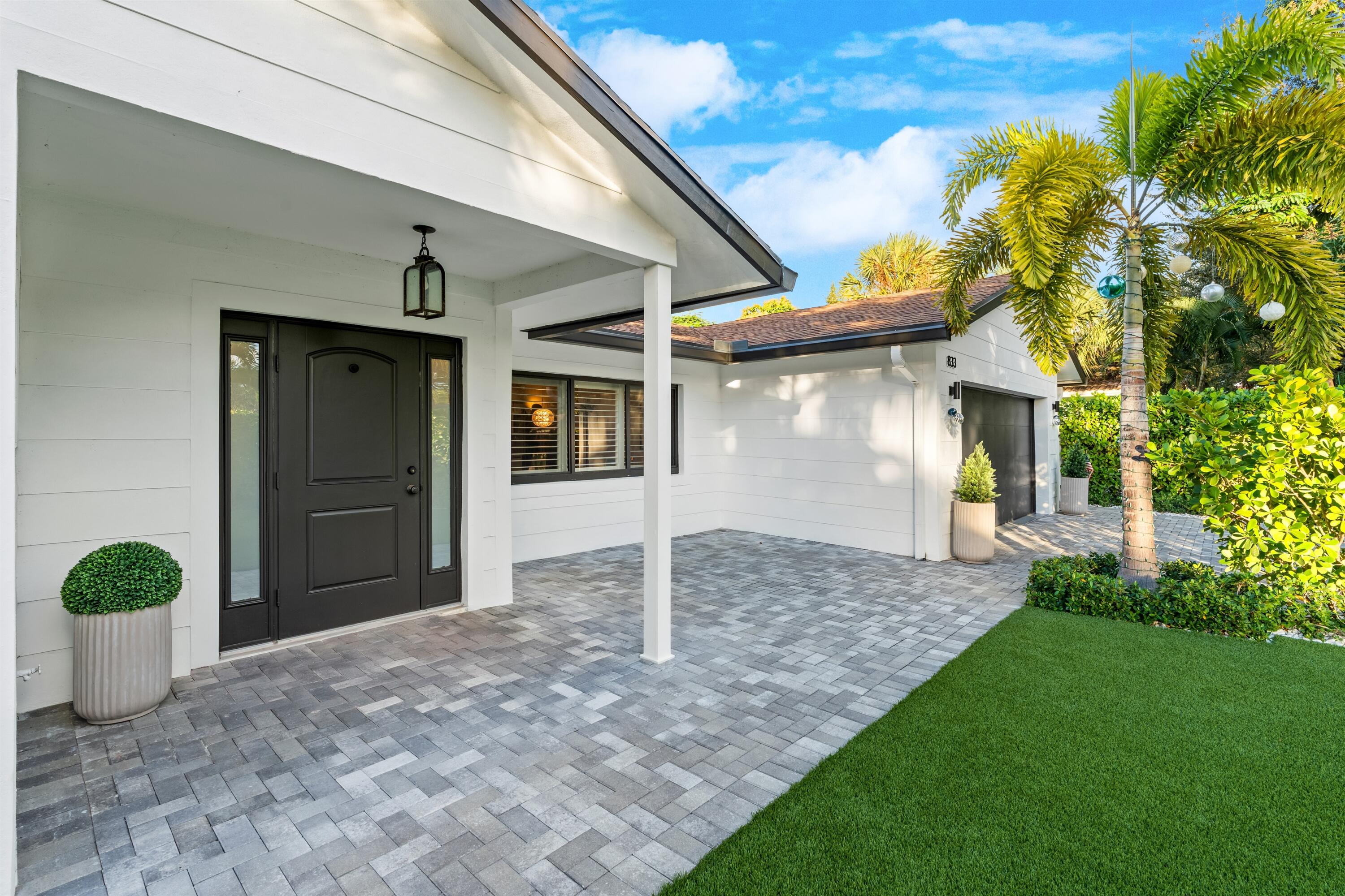 833 Northwest 6th Terrace Boca Raton, FL 33486 - Photo 8 of 49 a view of a house with a yard and potted plants