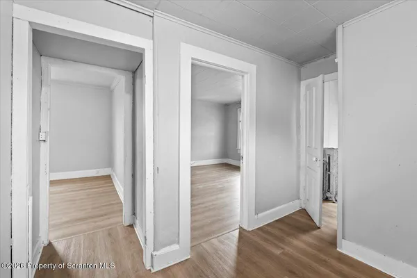 a view of a hallway with wooden floor