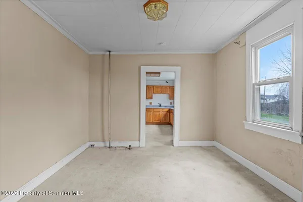 a view of an empty room and window