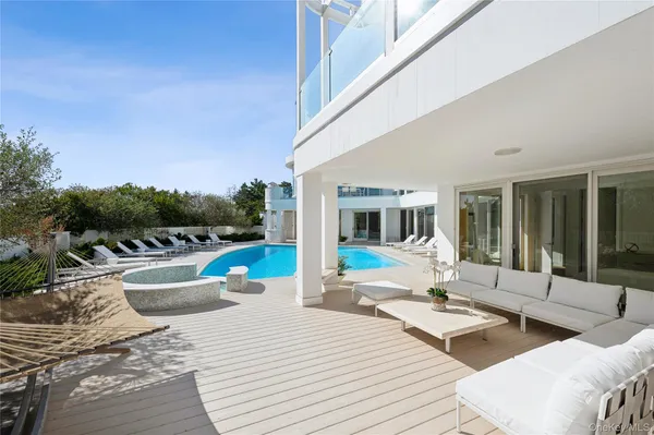 a view of a house with swimming pool and sitting area