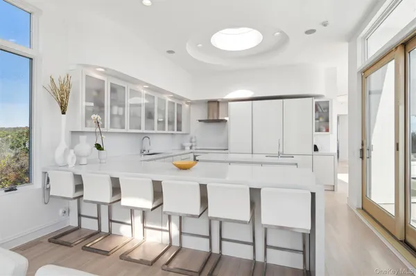 a kitchen with a sink and wooden floor