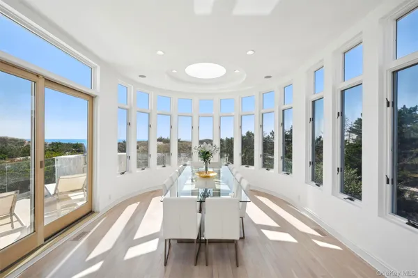 a view of an entryway with wooden floor and a livingroom view