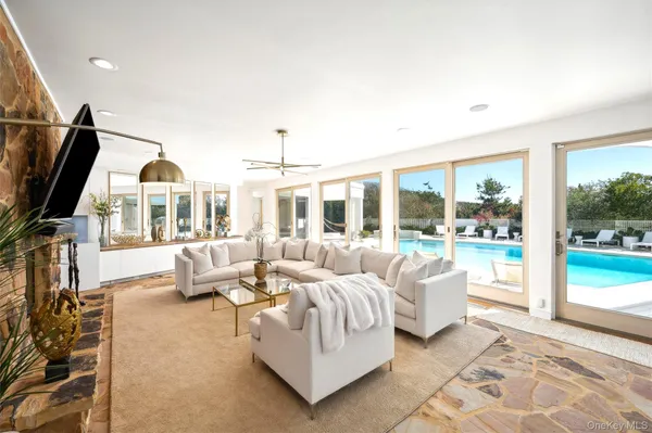 a living room with furniture and large windows