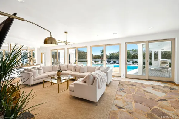 a living room with furniture and large windows