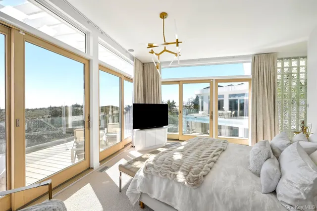 a view of a balcony with wooden floor and outdoor seating