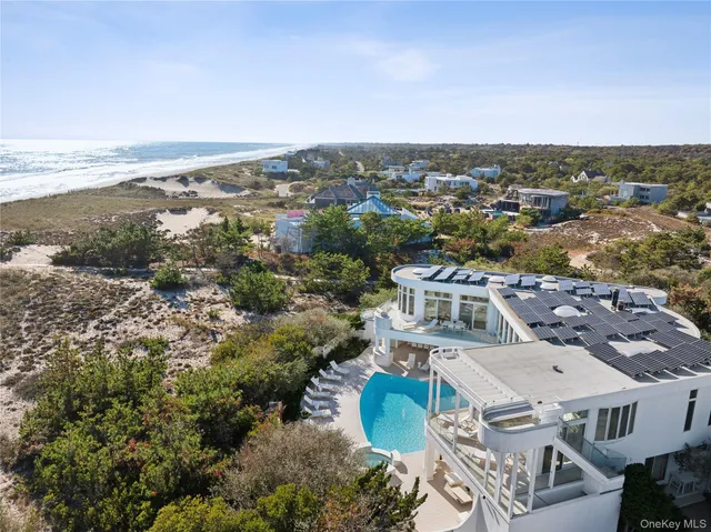 a bedroom with a large bed and a flat tv screen