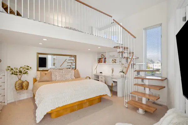 a spacious bedroom with a bed and a couch