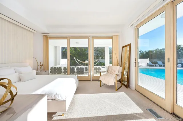 a spacious bedroom with a large bed and a large window