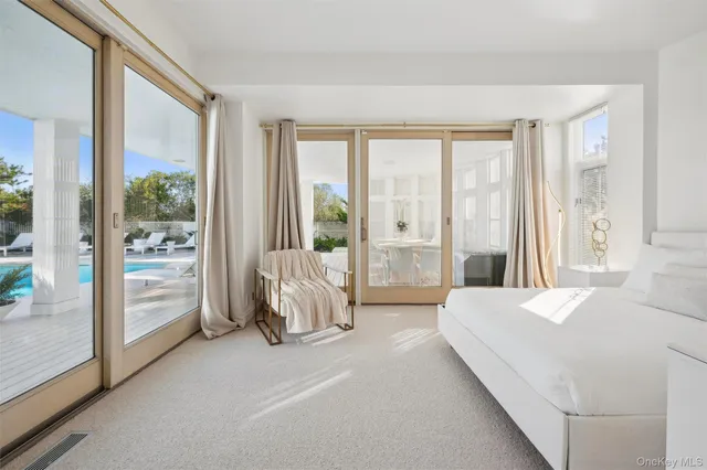 a room with a bed and a large window