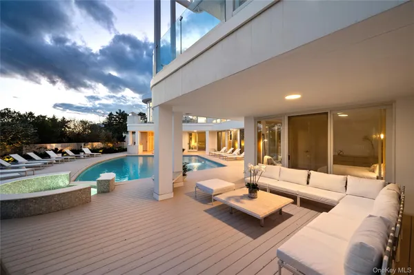a view of a house with swimming pool in front of it
