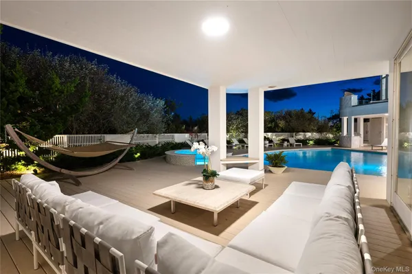 a view of swimming pool with outdoor seating
