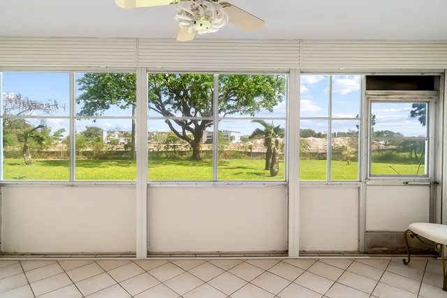 a living room with a large window and chandelier