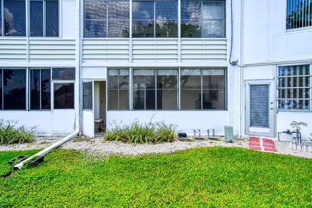 a view of house with yard and front view of a house