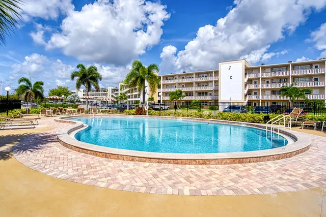 a view of swimming pool with outdoor seating and city view