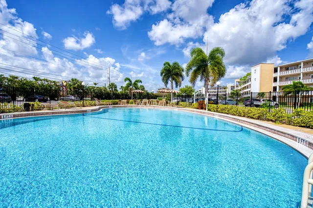 a view of swimming pool with outdoor seating and a patio