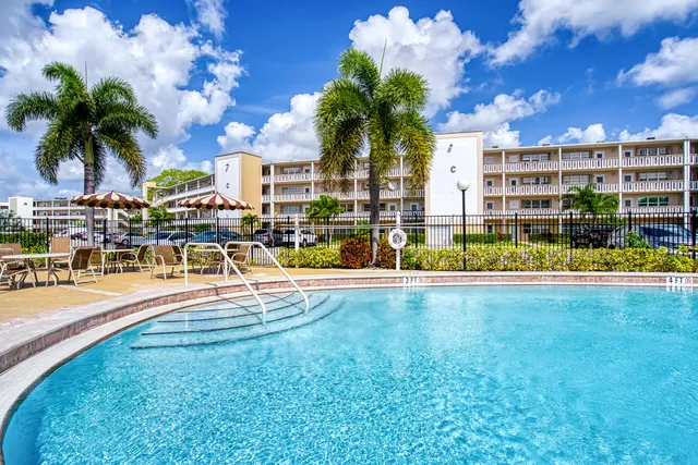 a front view of house with yard and outdoor seating
