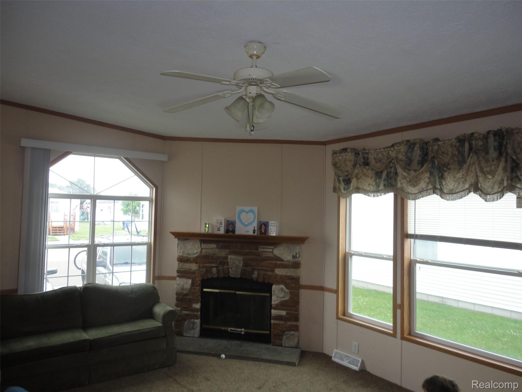 5931 Megans Ridge Monroe, MI 48161 - Photo 6 of 13 Family room featuring a stone-clad fireplace with a wood mantel