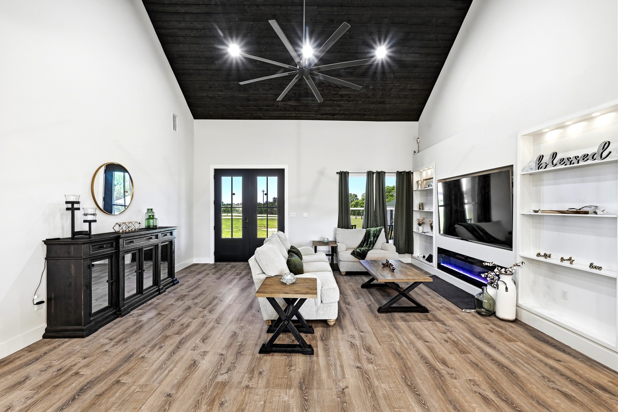 2889 Old McMahan Road Lockhart, TX 78644 - Photo 10 of 33 Tall ceilings and abundant natural illumination enhance this inviting living space with rich wooden floors.