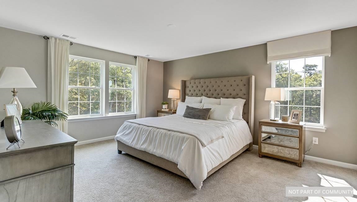 601 Scotty, Unit 1404 Rio Grande, NJ 08242 - Photo 16 of 26 a bed sitting in a spacious bedroom next to a window