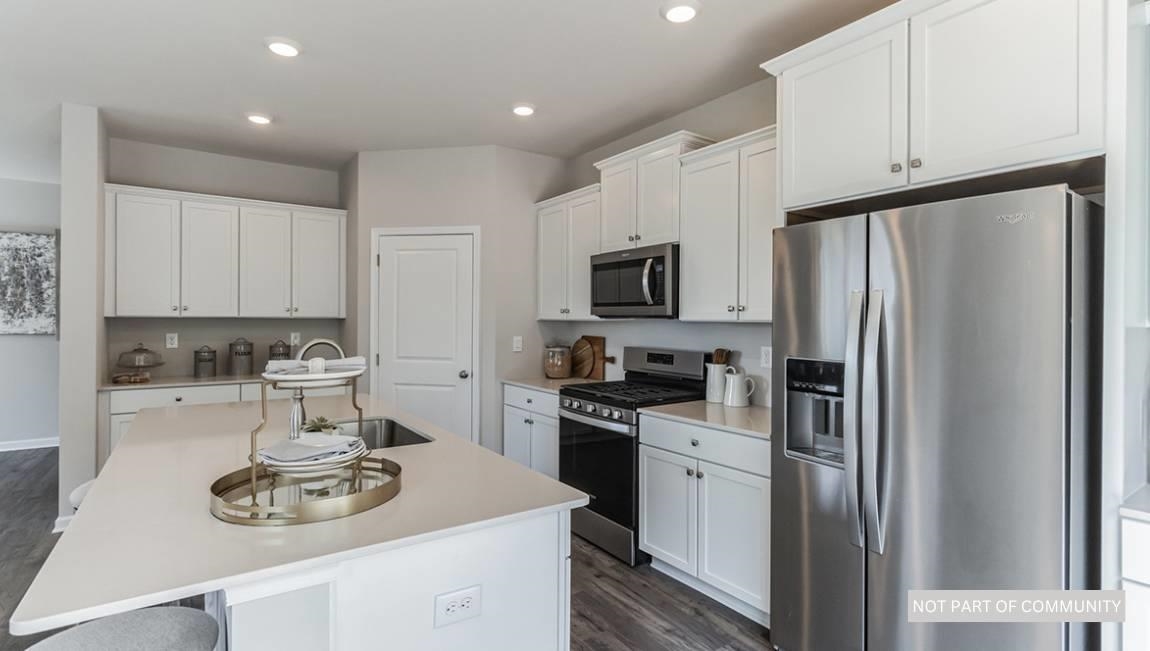 601 Scotty, Unit 1404 Rio Grande, NJ 08242 - Photo 6 of 26 a kitchen with stainless steel appliances a refrigerator stove and white cabinets