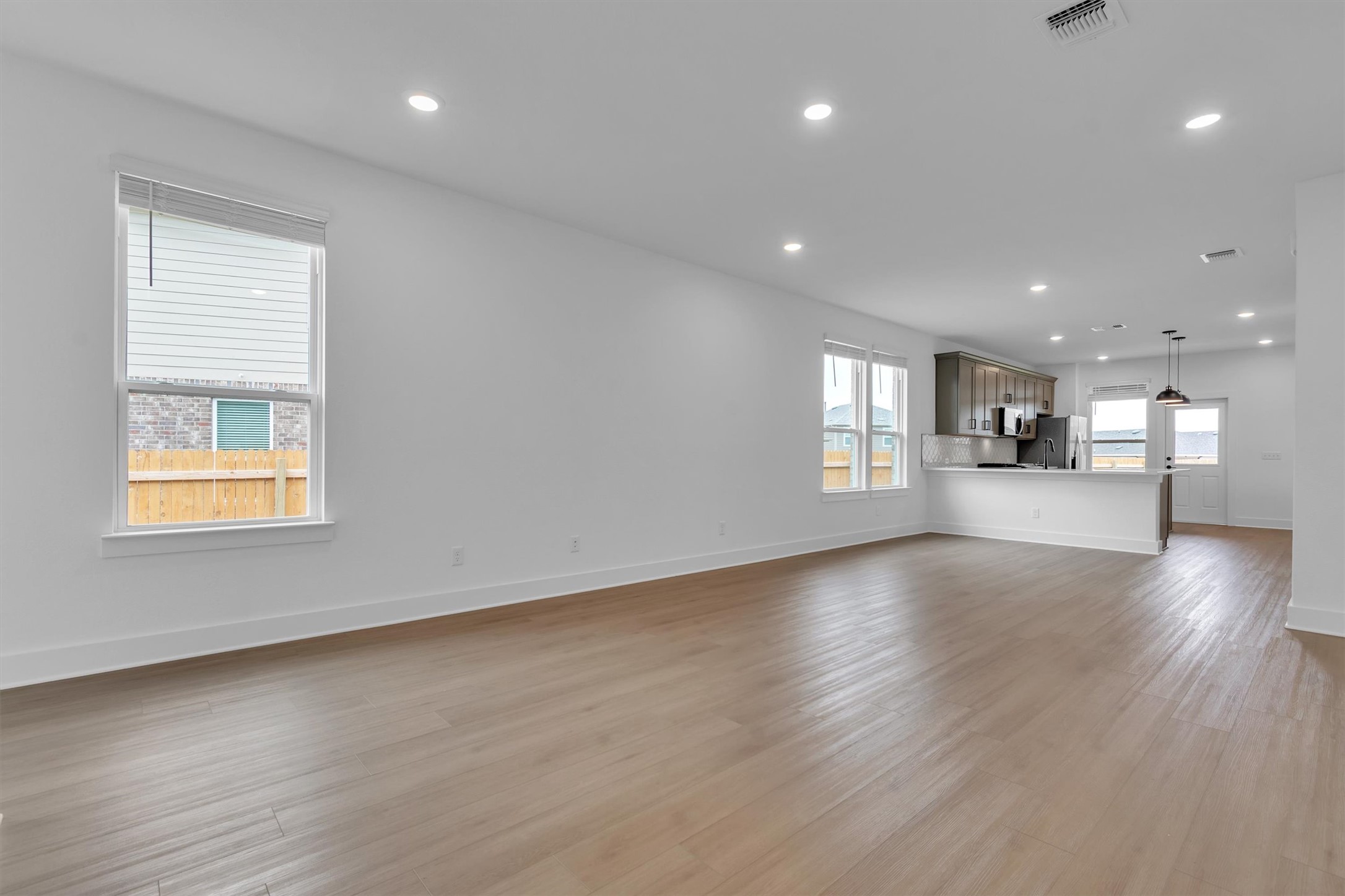 368 Bridge Deck Loop Kyle, TX 78640 - Photo 14 of 40 Unfurnished living room with light wood-style flooring, baseboards, and recessed lighting