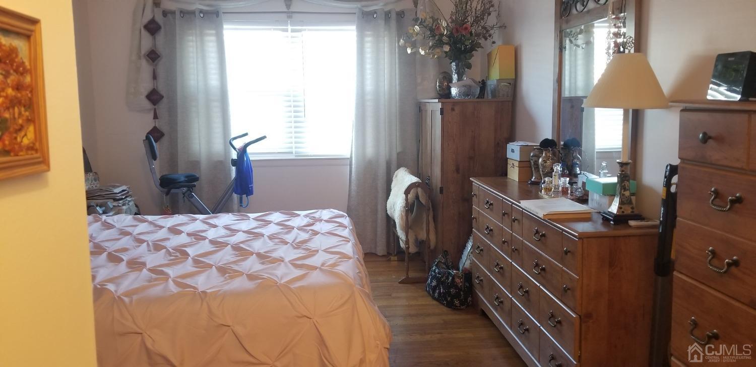 183 Evergreen Road, Unit 6A Edison, NJ 08837 - Photo 16 of 23 a bedroom with a bed a dresser and next to a window