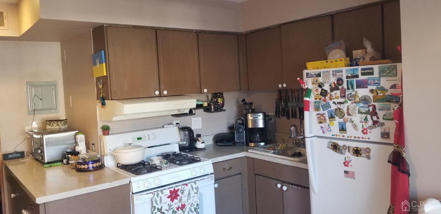 183 Evergreen Road, Unit 6A Edison, NJ 08837 - Photo 10 of 23 a kitchen with refrigerator and cabinets