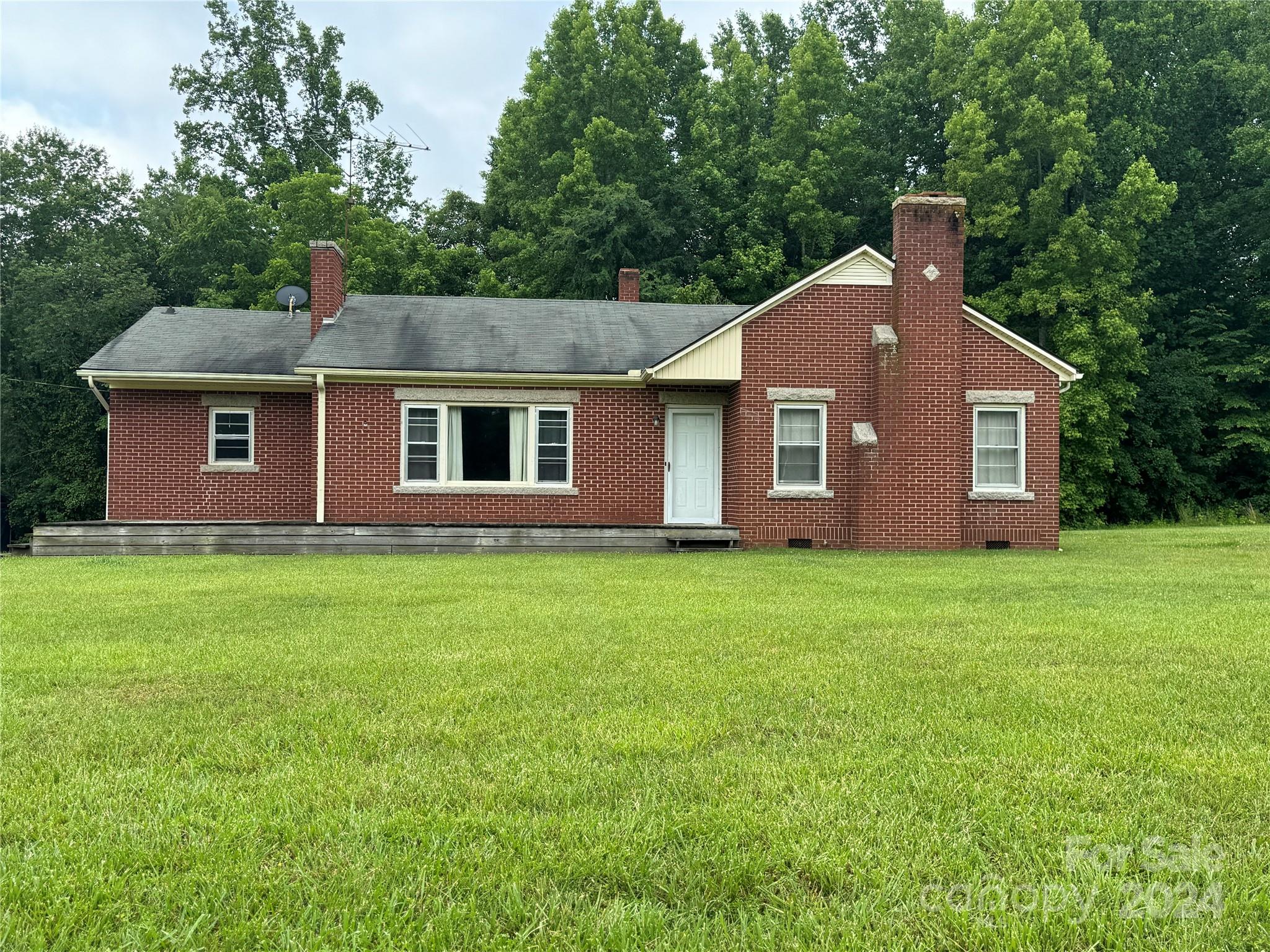 1555 Lower Palmer Road Rockwell, NC 28138 - Photo 2 of 17 a front view of a house with a garden