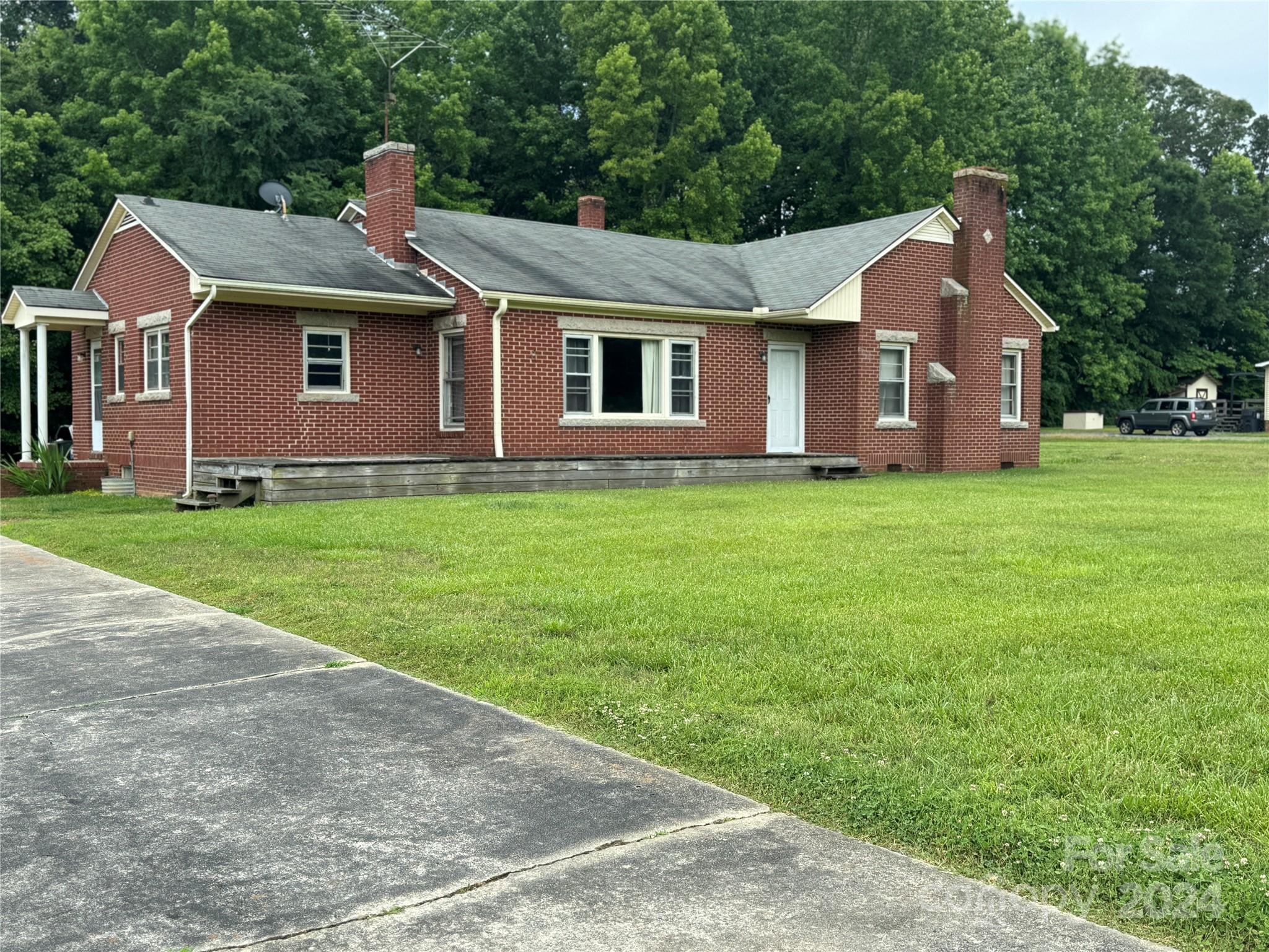 1555 Lower Palmer Road Rockwell, NC 28138 - Photo 3 of 17 a front view of a house with garden