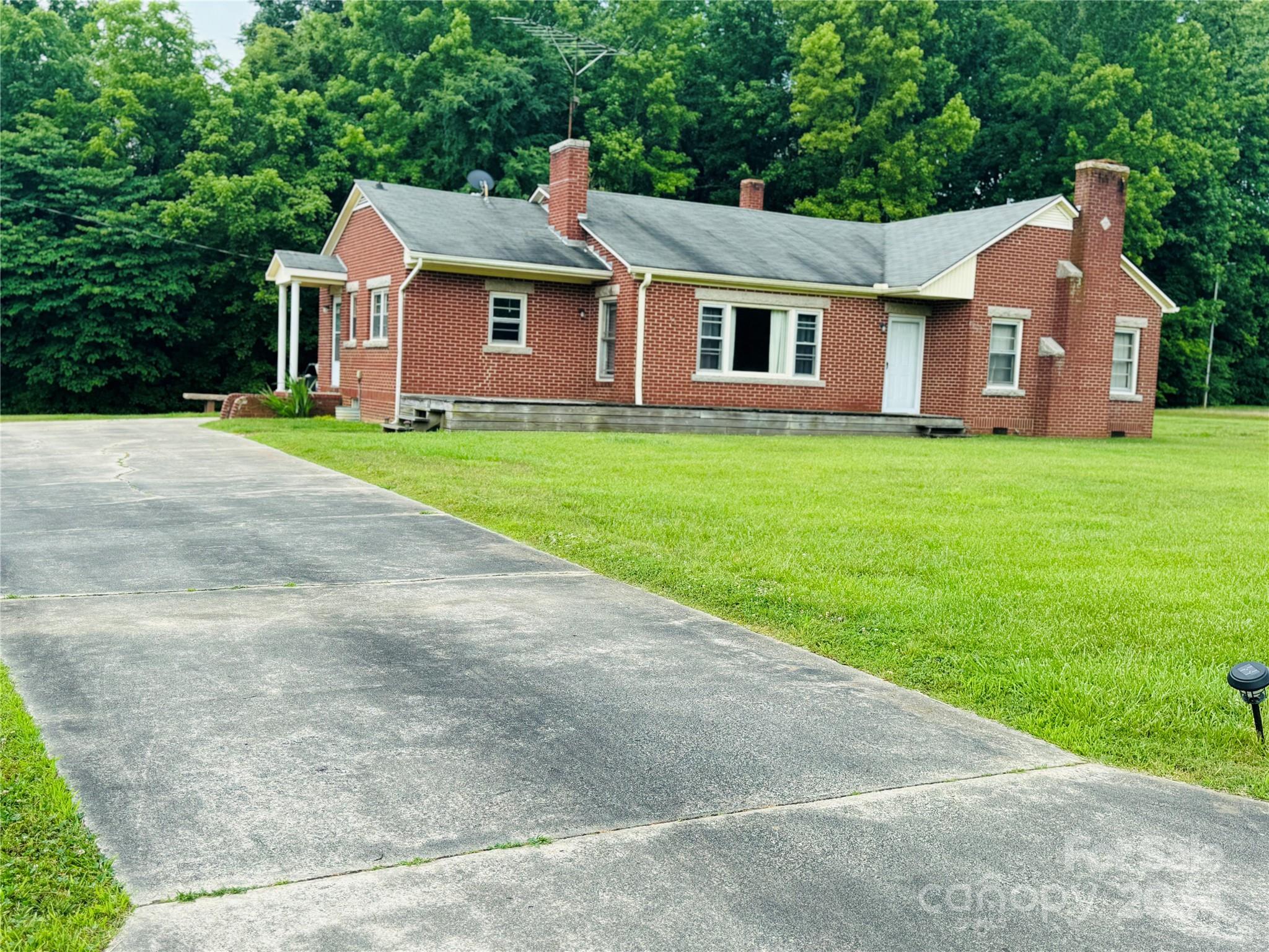 1555 Lower Palmer Road Rockwell, NC 28138 - Photo 4 of 17 a front view of a house with a garden