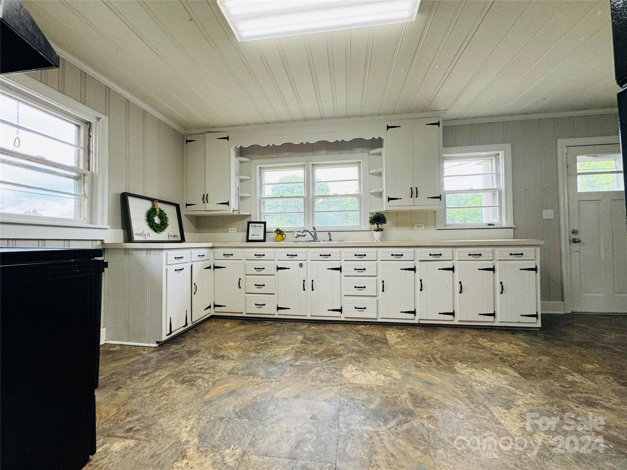 1555 Lower Palmer Road Rockwell, NC 28138 - Photo 7 of 17 a kitchen with granite countertop a sink and cabinets