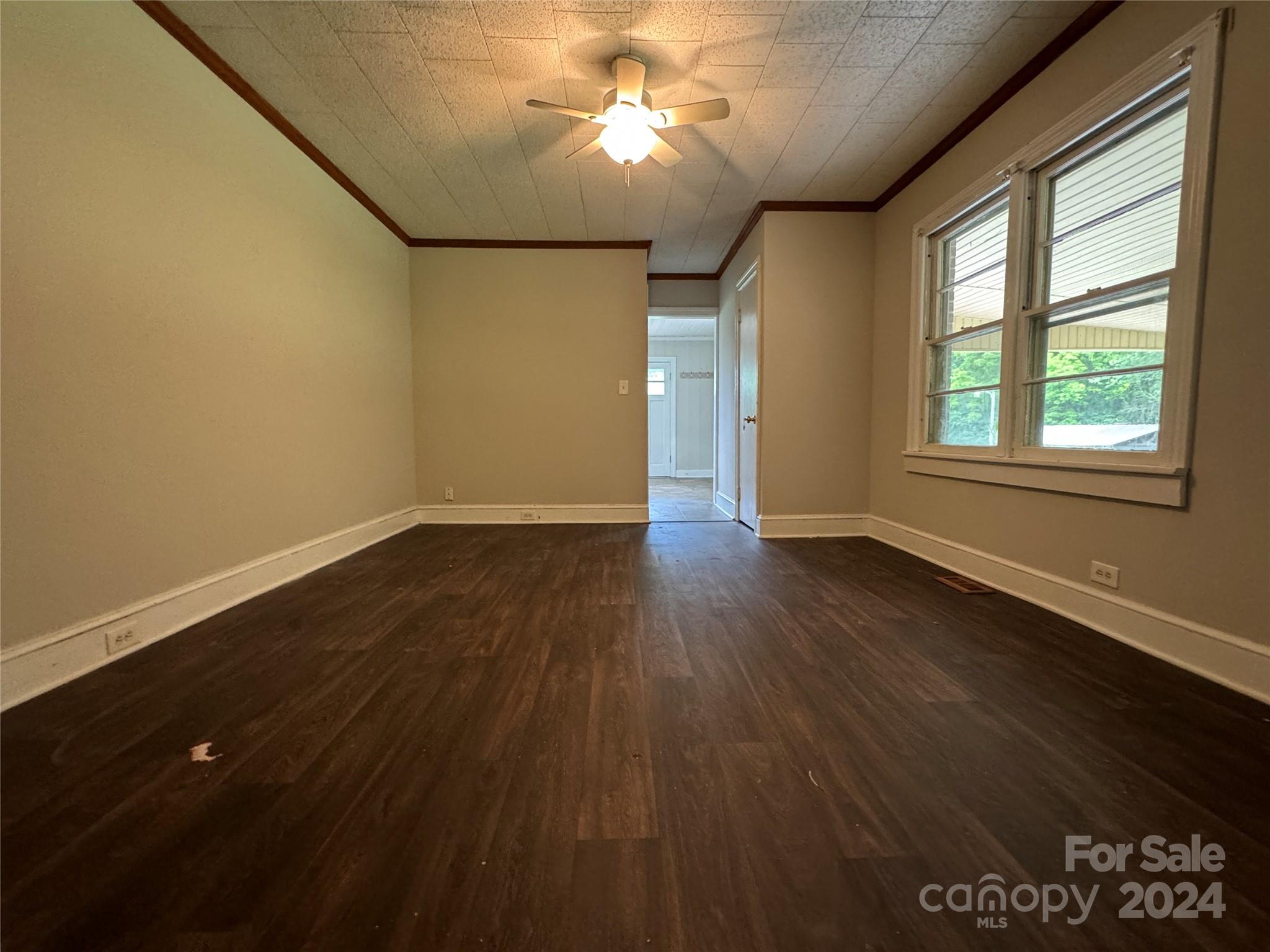 1555 Lower Palmer Road Rockwell, NC 28138 - Photo 9 of 17 an empty room with wooden floor and windows