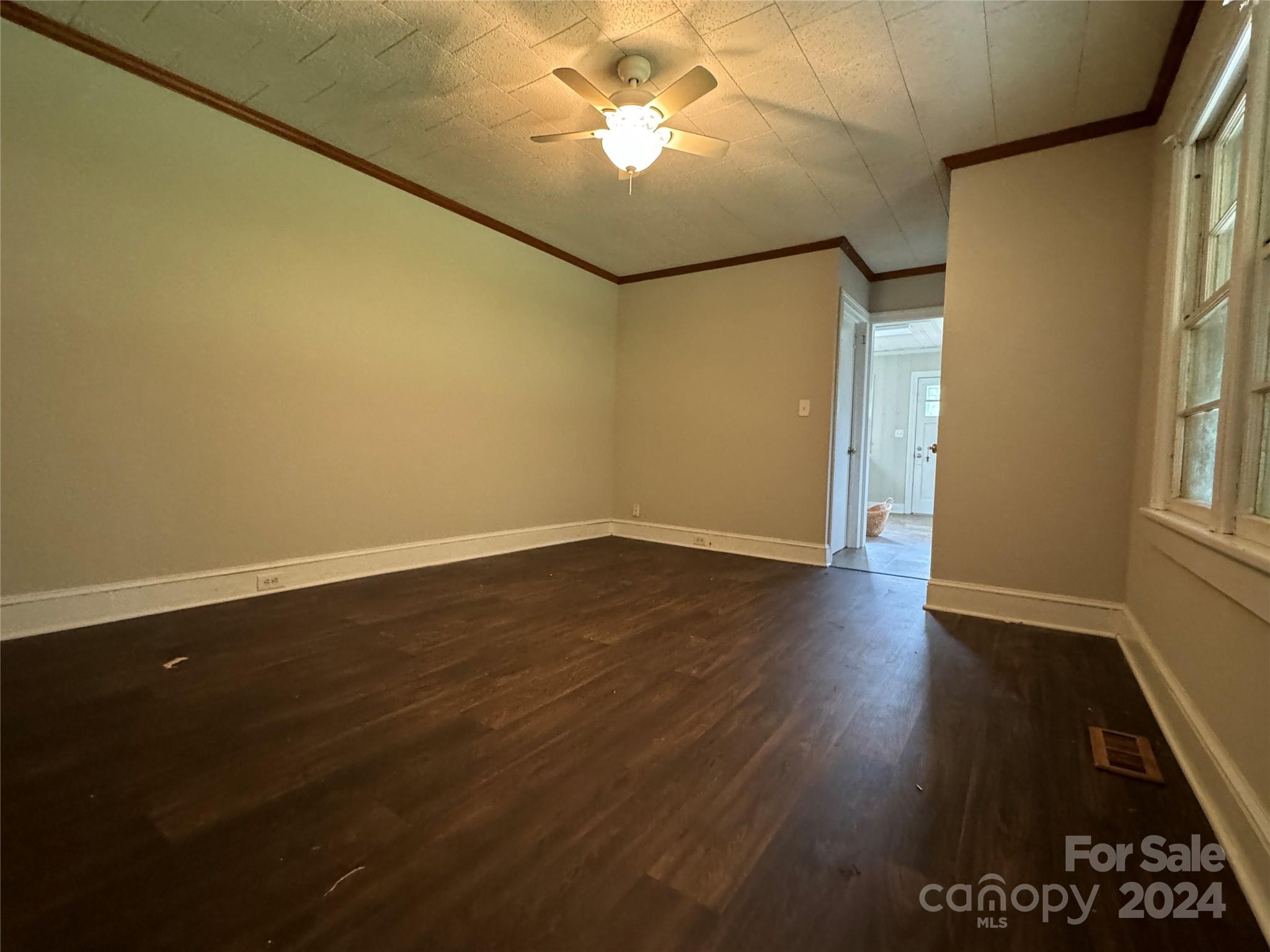 1555 Lower Palmer Road Rockwell, NC 28138 - Photo 10 of 17 an empty room with wooden floor and windows