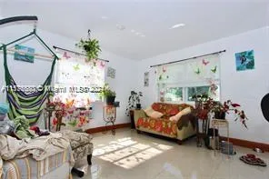 a living room with furniture and a painting on the wall