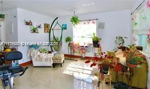 a living room with furniture and flowers