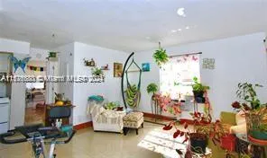 a living room with furniture and flowers