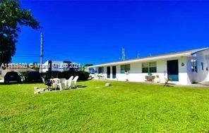 a view of a house with backyard porch and sitting area