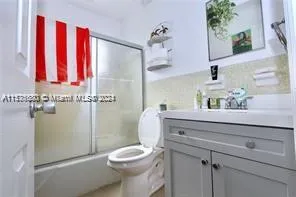 a bathroom with a sink a toilet and shower curtain