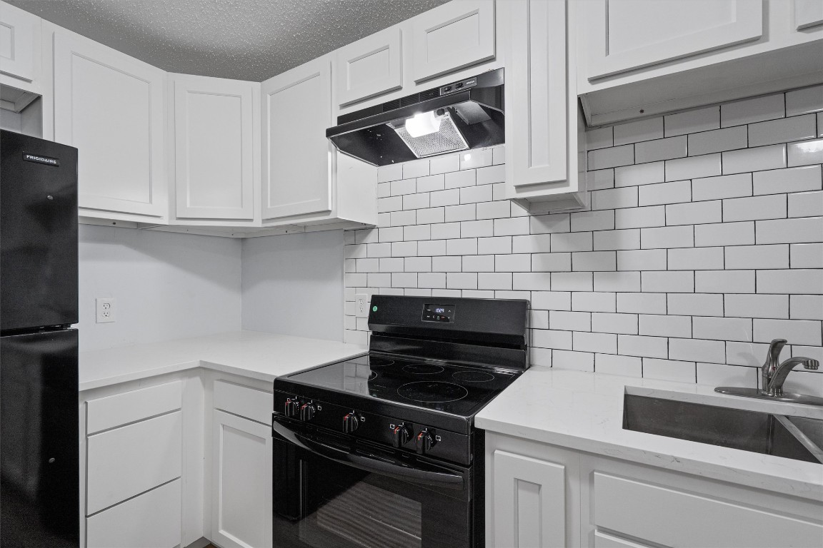 520 Lenora Drive, Unit A Taylor, TX 76574 - Photo 11 of 24 a kitchen with a sink and cabinets