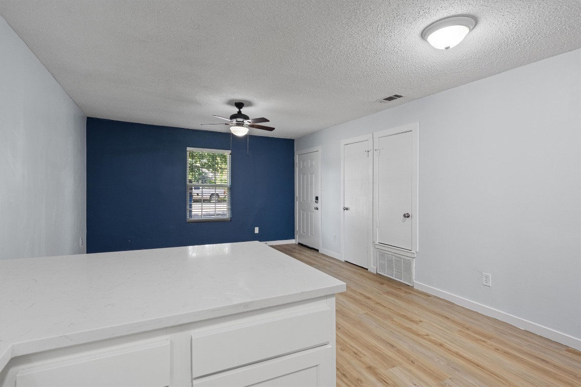 520 Lenora Drive, Unit A Taylor, TX 76574 - Photo 12 of 24 a room with a chandelier fan and wooden floor