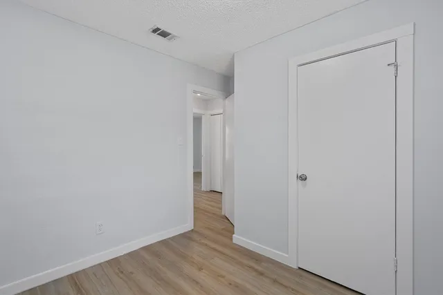 a bathroom with a bathtub shower sink mirror vanity and toilet