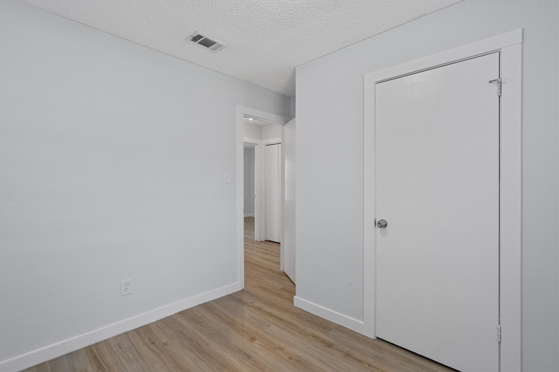 520 Lenora Drive, Unit A Taylor, TX 76574 - Photo 18 of 24 a view of an empty room with wooden floor