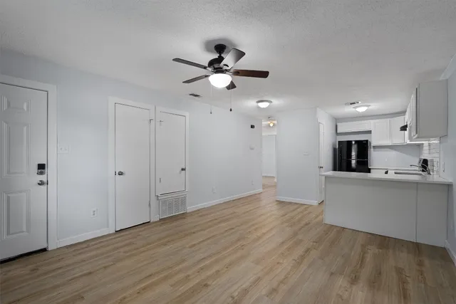 a view of a kitchen with wooden floor and a kitchen