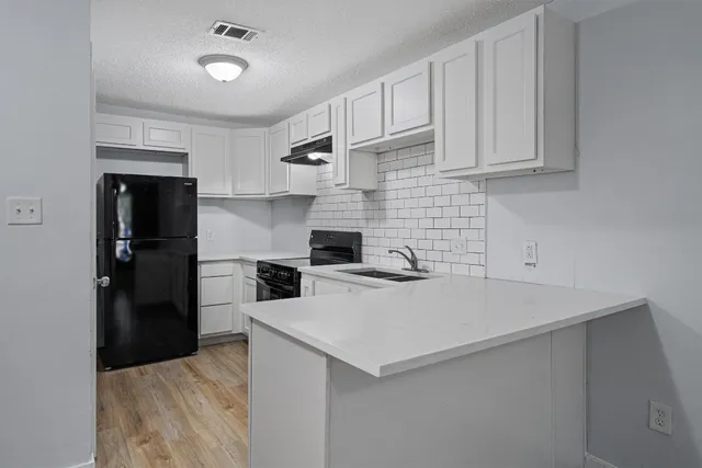 a kitchen with a sink and refrigerator