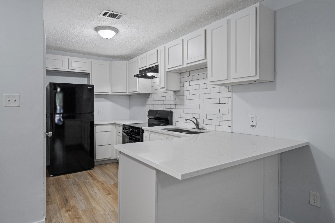 520 Lenora Drive, Unit A Taylor, TX 76574 - Photo 3 of 24 a kitchen with a sink and refrigerator