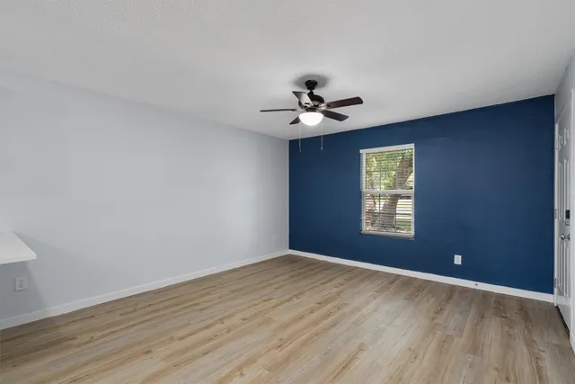 a view of kitchen with wooden floor a ceiling fan and wooden floor