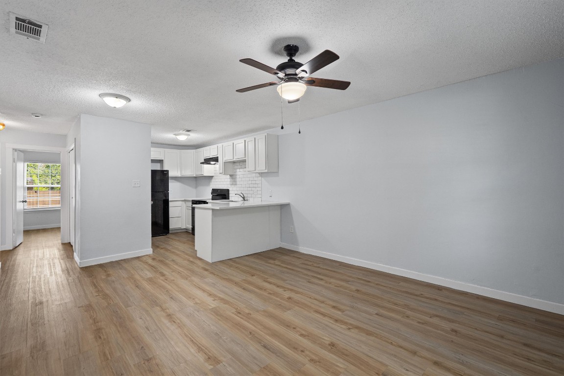520 Lenora Drive, Unit A Taylor, TX 76574 - Photo 9 of 24 a view of kitchen with wooden floor a ceiling fan and wooden floor